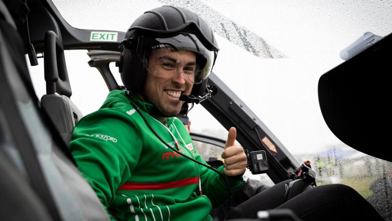Tickford Racing driver Thomas Randle in the front seat of an EC-135 helicopter at Mount Panorama during the Bathurst 1000. Photo: Leading Seaman David Cox