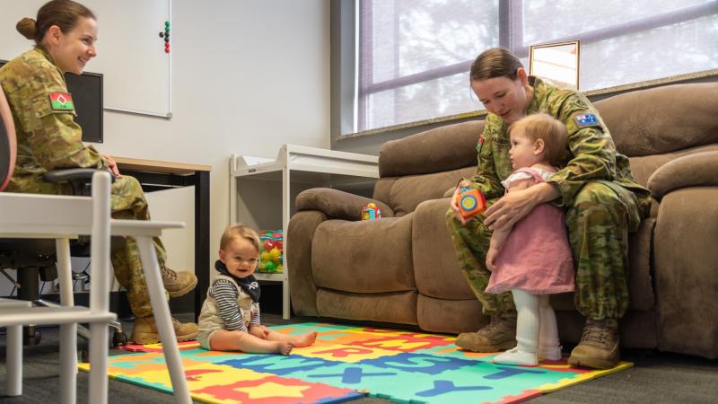 Captain Stephanie Costa, left, and Corporal Britney Pascoe with their bubs in the parents room. Photo: Major Paul Krohn