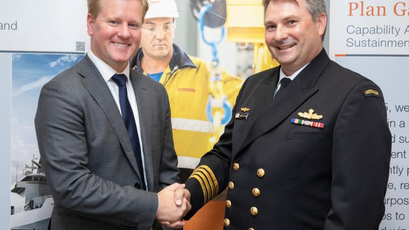 BAE Systems Destroyer Enterprise Program Manager Mr Shaun Connelly, left, and Deputy Director Ships Program Office Captain Grant McLennan at the completion of the signing of the capability life cycle manager contract. Photo: Petty Officer Bradley Darvill