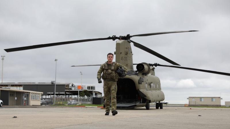 Corporal Darcy Enshaw, of 5th Aviation Regiment, on the flightline with a Chinook at Essendon Airport, Victoria. Photo: Captain Carolyn Barnett