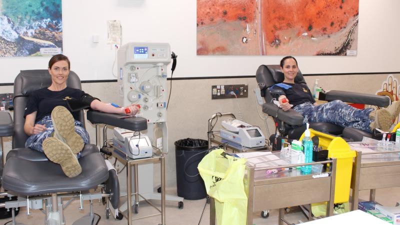 464 Squadron public affairs officers, Flight Lieutenants Kate Davis, left, and Steffi Blavius donate blood at a Red Cross Lifeblood Donation Centre in Melbourne as part of the Defence Blood Challenge. Photo: Supplied