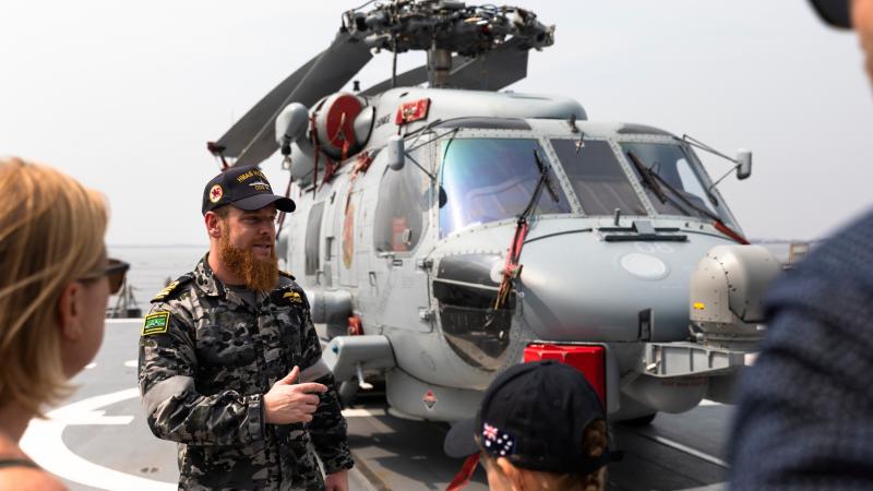 Flight Commander Lieutenant Commander Thomas Craig talks with guests from the Australian Embassy in Manila, Philippines, during a tour of HMAS Hobart while berthed in Manila Bay. Photos: Leading Seaman Daniel Goodman