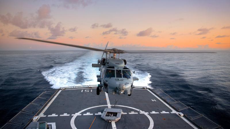 HMAS Arunta’s embarked MH-60R helicopter Athena conducts flying operations as the ship transits through the Indonesian archipelago during a regional presence deployment. Photo: Able Seaman Susan Mossop