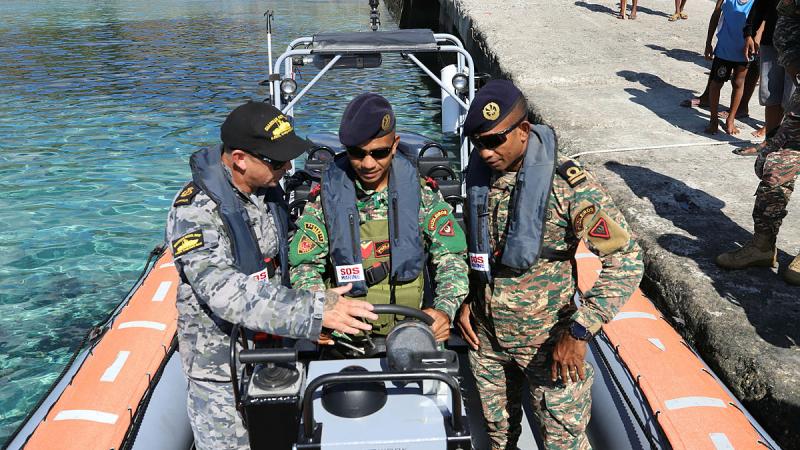 From left, RAN Chief Petty Officer Christian Duncan instructs 2TEN Mario Arujo and GRT Ezaqiel Ximenes in a Guardian Class patrol boat. Photo: Mrs Juliana Pereira