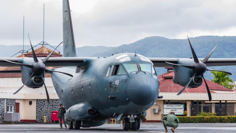 RAAF loadmaster Corporal Amanda Wintle, left, and pilot Flight Lieutenant Peter Wuttke from 35 Squadron conduct pre-flight checks on a C-27J Spartan aircraft at Pohnpei International Airport. Photos: Leading Aircraftman Sam Price