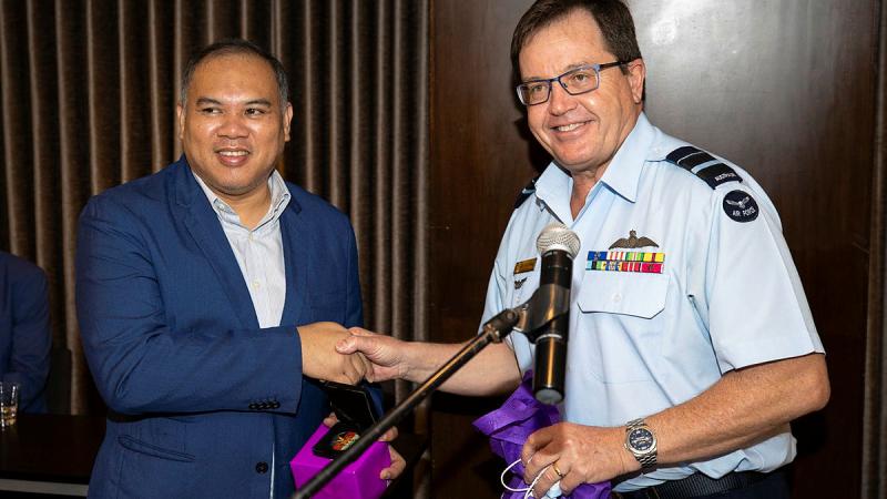 ADF Deputy Chief Joint Operations Command, Air Vice-Marshal Mike Kitcher, right, presents a gift to the Office of Civil Defence Deputy Administrator for Operations, Assistant Secretary Bernardo Rafaelito Alejandro IV. Phot: Brandon Grey