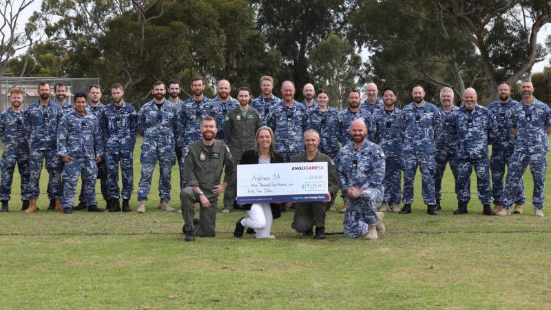Air Force SRG personnel. Front: (l-r) Squadron Leader Lachlan Adam, Anglicare Fundraising Coordinator Tammy Rees, Officer Commanding 92 Wing Group Captain Paul Carpenter and Sergeant Richard Wren at RAAF Base Edinburgh, SA. Photo: Sergeant Bill Solomou