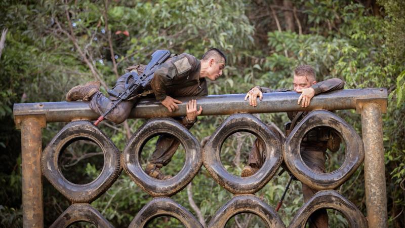 French Armed Forces in New Caledonia soldier Private Thimeo, left, climbs over a vertical tyre obstacle during Exercise True Grit at the Tully training area, Queensland. Photo: Sergeant Matthew Bickerton