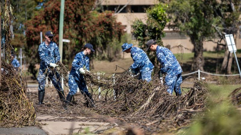From left, Aircraftman Haydn Mcgovern, Aircraftwoman Ellenah Wall, Sergeant Adam Thomas and Leading Aircraftman Frank Schinella help clean Duck Park in Moree, NSW, after the recent flood events. Photo: Leading Aircraftman Samuel Miller