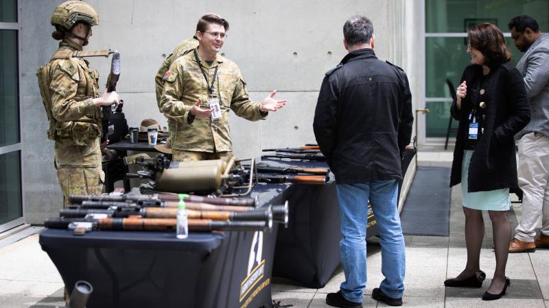 Captain Damien Freeman talks about captured enemy weapons during a display by the Australian Army History Unit at Russell Offices, Canberra. Photo: Sergeant Matthew Bickerton