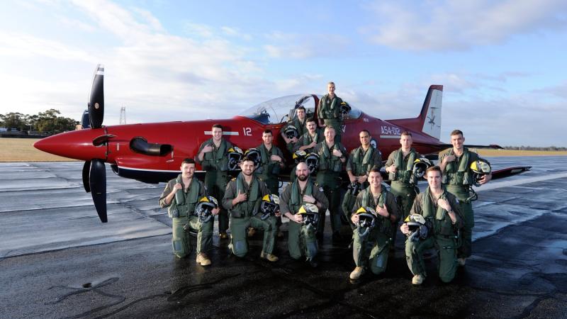 Graduates from the 267 ADF Pilots Course with a Pilatus PC-21 on the flight line at RAAF Base Pearce. Photo: Chris Kershaw