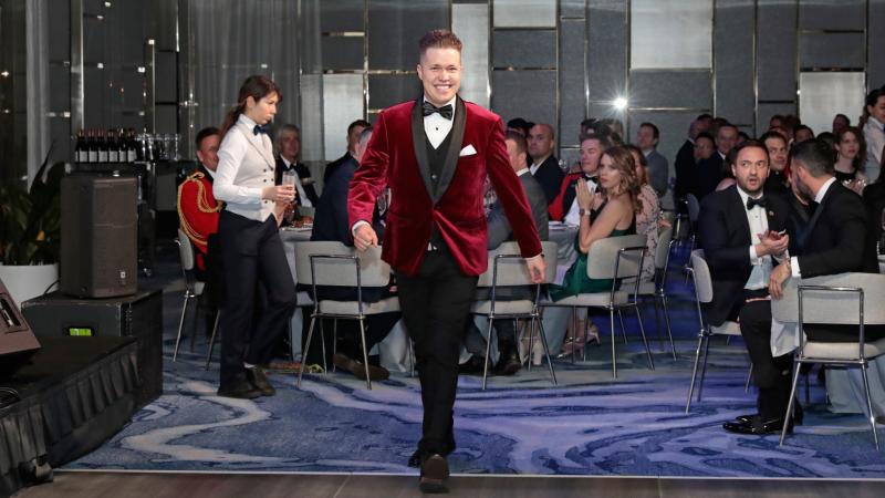 Signaller Harry Gifford walks up to the stage to collect the award for Excellence and Inclusion, at the Defence Gay and Lesbian Information Service Military Pride Ball in Sydney. Photo: Ann-Marie Calilhanna