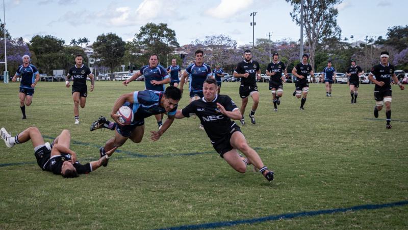 Sapper Jack Arrowsmith carries the ball in attack with Corporal Joshua Allen and Lance Corporal Siaka King in support, during ADF v NZDF rugby union test, Brisbane. Photo: Corporal Miguel Anonuevo