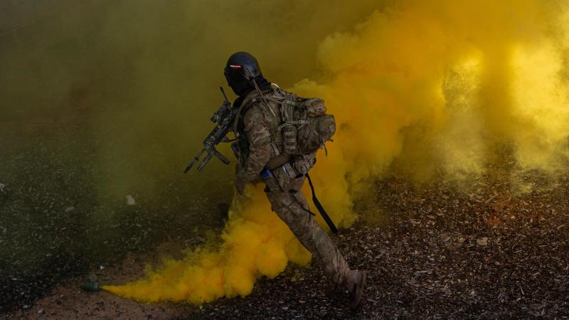Army rifleman from Charlie Company of the 8th/9th Battalion, Royal Australian Regiment, uses smoke as cover to make entry into a building as part of Exercise Ram Horn IV. Photos: Corporal Nicole Dorrett