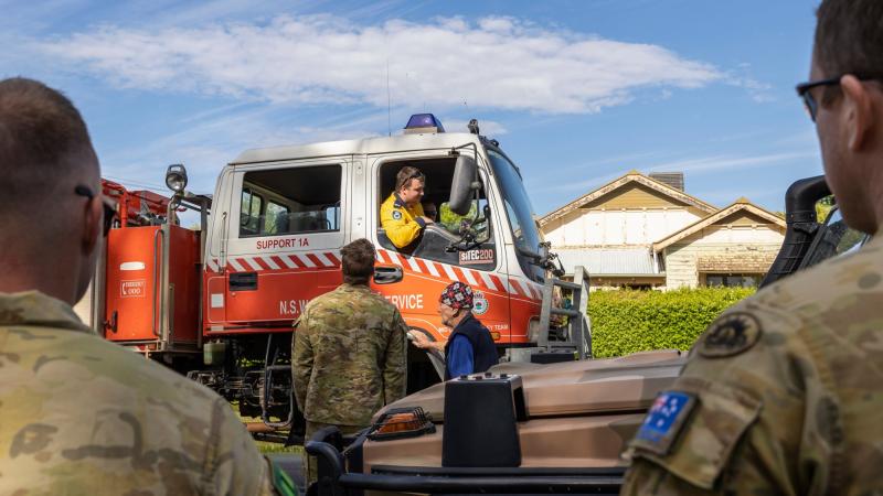 Australian Army soldiers and a local resident speak with a NSW Rural Fire Service volunteer in Forbes. Photo: Corporal David Cotton