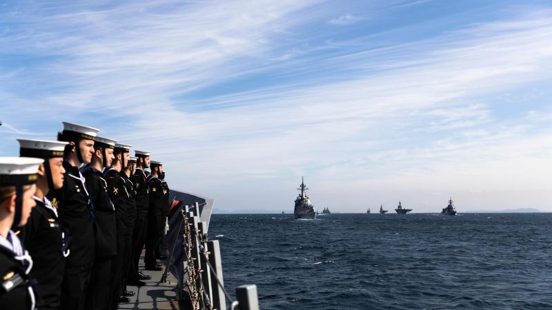 HMAS Hobart prepares to sail past the reviewing ship, Japan Maritime Self-Defense Force helicopter carrier JS Izumo, during the International Fleet Review 2022 off the coast of Yokosuka, Japan. Photos: Leading Seaman Daniel Goodman