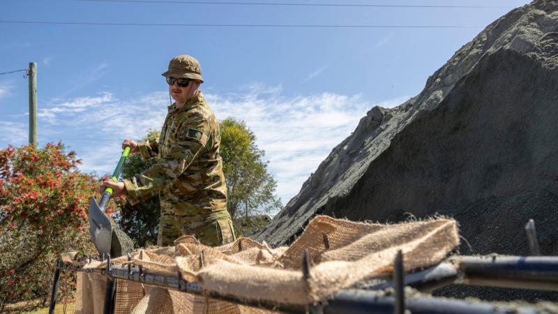 Army soldier Private Jayden Montgomerie from the 2nd Battalion, Royal Australian Regiment, conducts sand bagging at the Forbes NSW SES depot, during Operation Flood Assist. Photo: Corporal David Cotton