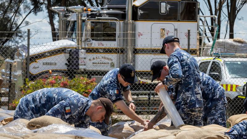 Air Force personnel wrap sandbag pallets for transportation at the NSW State Emergency Service depot in Forbes, during Operation Flood Assist. Photo: Corporal David Cotton