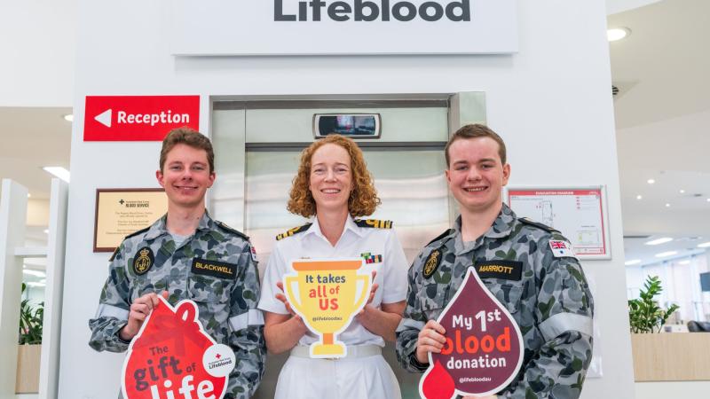 HMAS Encounter Commanding Officer Commander Emma McDonald-Kerr, centre, with Midshipmen Benjamin Blackwell and Max Marriott at the Red Cross Lifeblood Centre, Adelaide. Photo: Leading Aircraftman Sam Price