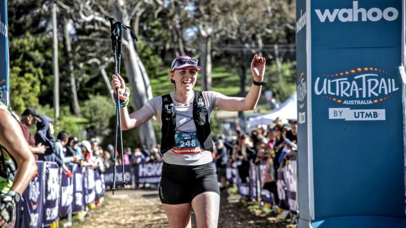 Captain Meghann Coffey, a physio from the 1st Health Battalion, crosses the finish line during an ultra-trail marathon in Katoomba.