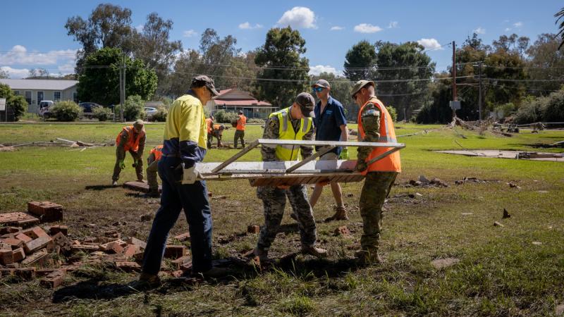 ADF personnel assist council workers to restore the memorial located in Eugowra, NSW, during Operation Flood Assist 22-2. Photo: Corporal Madhur Chitnis