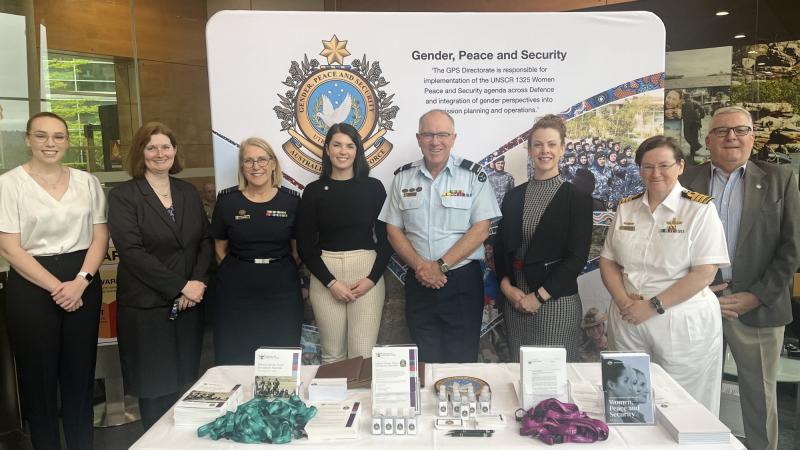 Air Commodore Grant Pinder with members of the Gender, Peace and Security Directorate and Joint Support Services Division at an information stand in Canberra. Photo: Emily Egan