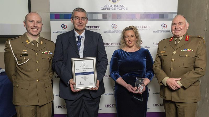 Mark Hebblethwaite of Extreme Networks, winner of Private sector – small, is joined by Major Darren Brilliant, left, Lisa Eling - Head of Joint Support Services Division, and Major General Douglas Laidlaw, right. Photo: Private Michael Currie