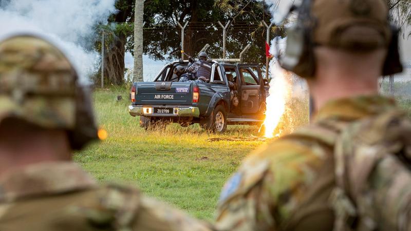 Air Force Airfield Defence Guards from 2 Security Forces Squadron watch a quick reaction force demonstration by the Royal Malaysian Air Force Security Squadron. Photos: Sergeant Ben Dempster