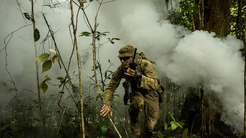 Soldier Trooper Jakob West from Rifle Company Butterworth Rotation 137 fights through the final objective, covering arduous terrain through dense jungle. Photos: Bombardier Guy Sadler