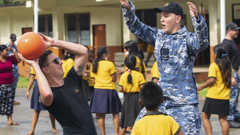 RAAF Flight Lieutenant Jayden Hasemann, left, and Leading Aircraftman Jack Atkins play basketball with students at Sokehs Roie Soledi Peidie Elementary School. Photos: Leading Aircraftman Sam Price