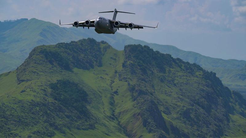 A RAAF C-17 Globemaster III flies in a 2-ship formation with a U.S. Air Force C-17 over Papua New Guinea. Photos: Staff Sergeant Alan Ricker