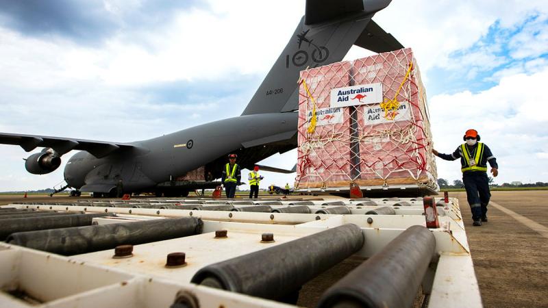Australian Aid pallets are unloaded from a RAAF C-17A Globemaster at Wattay International Airport in Laos. Photos: Sergeant David Said