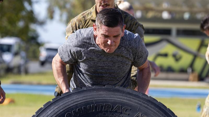 Queensland police and RAAF conduct a tyre flip during a training session at RAAF Base Amberley. Photo: Corporal Kieren Whiteley