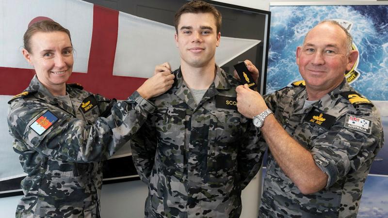 Able Seaman William Scott, centre, receives his promotion from Commodore Malcolm Wise, right, and Lieutenant Terri Jenkin at Fleet Headquarters, NSW. Photo: Leading Seaman Sittichai Sakonpoonpol