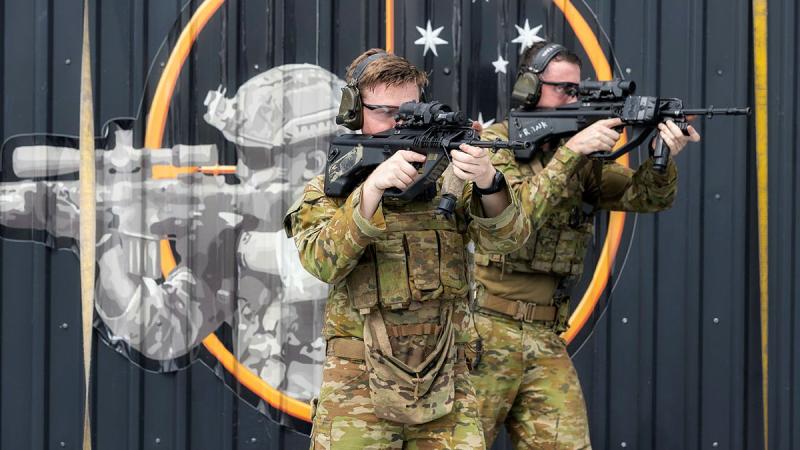 From left, Private Shane Bagley and Private Frank Atkinson of the 1st Battalion, Royal Australian Regiment on HMAS Adelaide. Leading Seaman Sittichai Sakonpoonpol