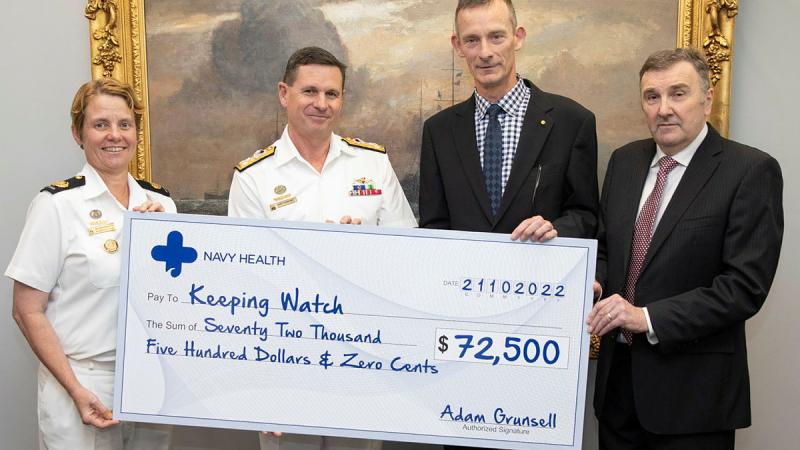 CEO of Navy Health, Mr Ron Wilson, right, and Director Navy Heath, Commodore Michael Miko, second from right, present Chief of Navy, Vice Admiral Mark Hammond, 2nd from left, and Warrant Officer of the Navy, Deb Butterworth, left, with a donation to Keeping Watch. Photo: Petty Officer Bradley Darvill