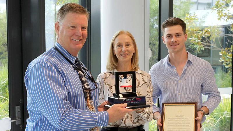 Capability Manager, School of Air Traffic Control, Mr Frank Jones, left, recipient of the 2022 Bellenger Bell award, with the family of the late Wing Commander Sean Bellenger. Photo: Petty Officer Richard Prideaux