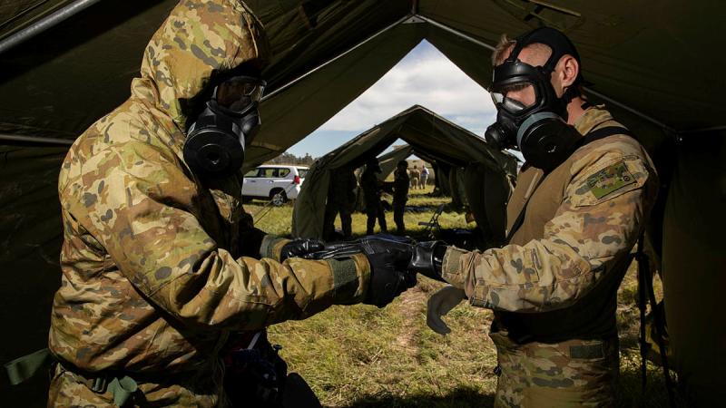 Combat Support Group aviators assisting role players during a decontamination scenario during Exercise Toxic Gauntlet. Photos: Corporal Brett Sherriff