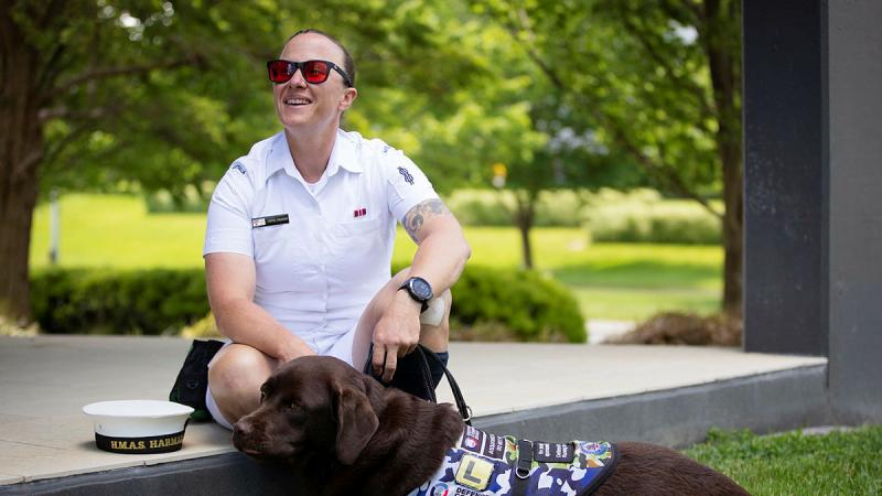 Able Seaman Taryn Dickens with her assistance dog, Gigi, at Brindabella Park, ACT. Photo: Private Nicholas Marquis