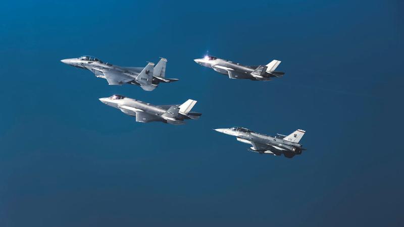 RAAF F-35A Lightning II and RSAF, F-16 Fighting Falcon and F-15SG Strike Eagle aircraft above Singapore.