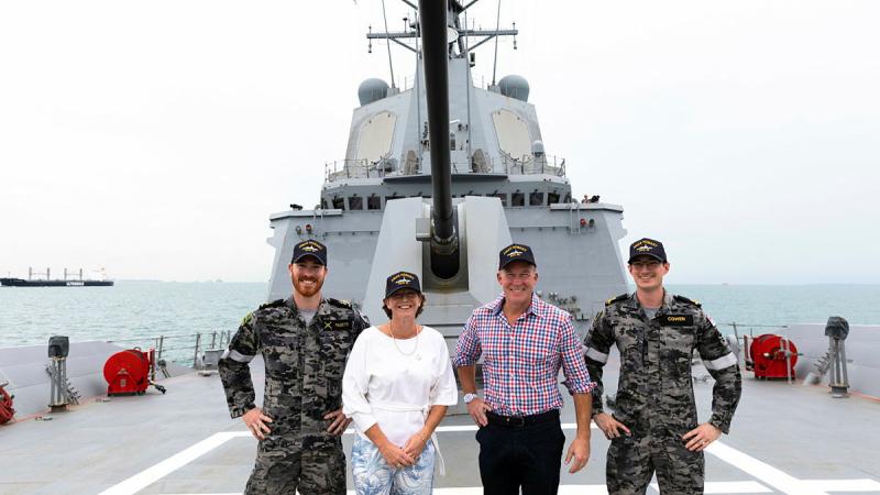 From left, Able Seaman Jordan Pagett, Ship Sponsor Nicola Hodgman, Australia's High Commissioner to Singapore Will Hodgman and Sub Lieutenant Bradley Cowen stand on the forecastle of HMAS Hobart in Singapore. Photo: Leading Seaman Daniel Goodman
