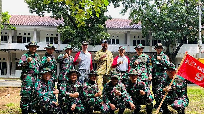 Lieutenant Commander Mark Graichen, centre rear, during a team building exercise with other students from his Indonesian Navy command and staff college course. 