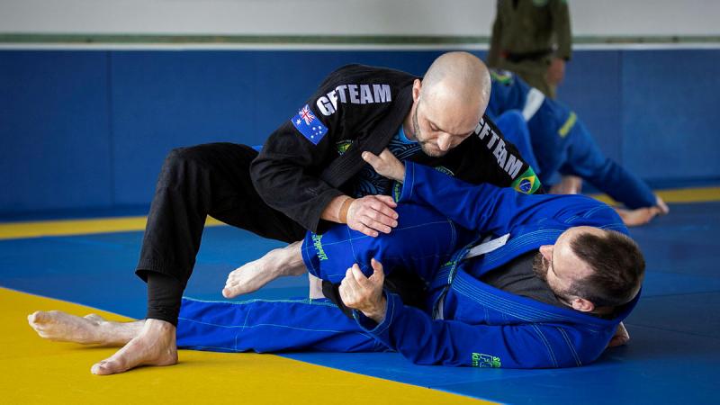 Petty Officer Nathan Smith, in black, during a Brazilian Jiu Jitsu training session at Grappling Bros, Canberra. Photo: Leading Seaman Kylie Jagiello