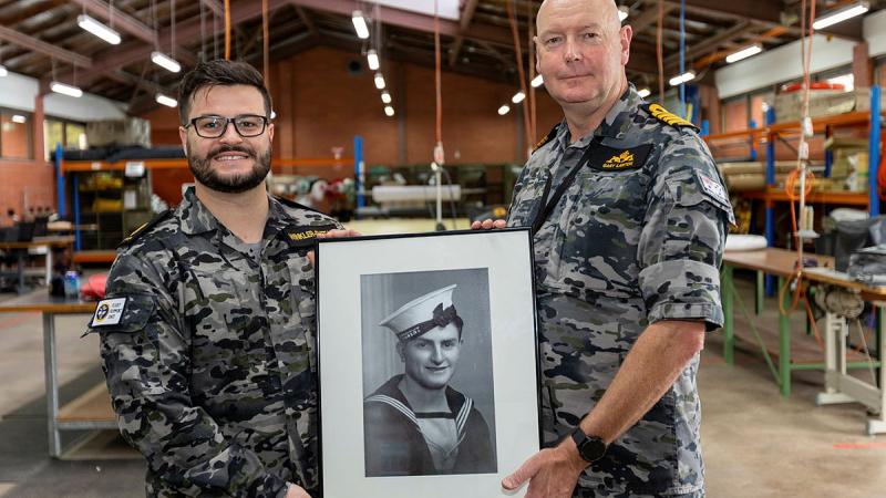 Able Seaman Boatswains Mate Billy Winkler-Sheean holds a portrait of Teddy Sheean VC with Commanding Officer HMAS Stirling Captain Gary Lawton after his promotion ceremony. Photo: Chief Petty Officer Yuri Ramsey