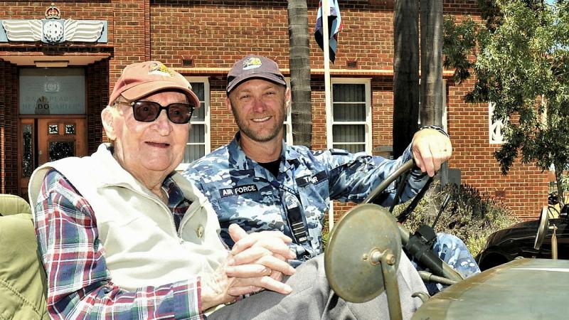 Flying Officer (retd) John 'Blue' Bailey, left, and Commanding Officer of 25 Squadron Wing Commander Paul Taylor pose in a world war jeep replica at RAAF Pearce. Photo: Squadron Leader Roger Buddrige