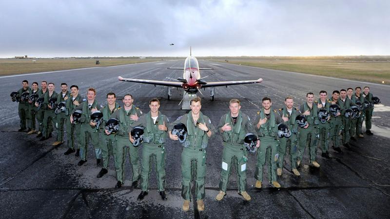 The 268 ADF Pilots Course members assemble at dawn on the flight line with a Pilatus PC-21 aircraft at RAAF Base Pearce in Western Australia. Photo: Chris Kershaw