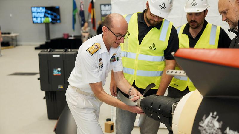 Director General Warfare Innovation, Royal Australian Navy, Commodore Darron Kavanagh inspects the ‘Dive-LD’ autonomous underwater vehicle. Photos: Dan Gosse Images