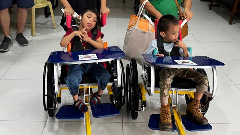 Children in the Philippines using the wheelchairs delivered to them with help from the Royal Australian Air Force.