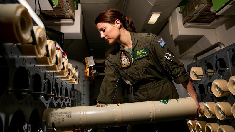 Air Force Sergeant Taryn Allen with a modern version of the sonobuoy on board a P-8A Poseidon during Exercise Talisman Sabre in 2021. Photo: Leading Aircraftwoman Emma Schwenke