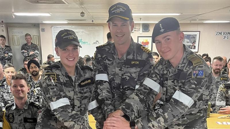 HMAS Choules’ Commanding Officer Commander Ross Upton and the two youngest members of Ships Company; Seaman Marigold Kraemer and Private Jack Haverfield, cut the 11th anniversary cake.